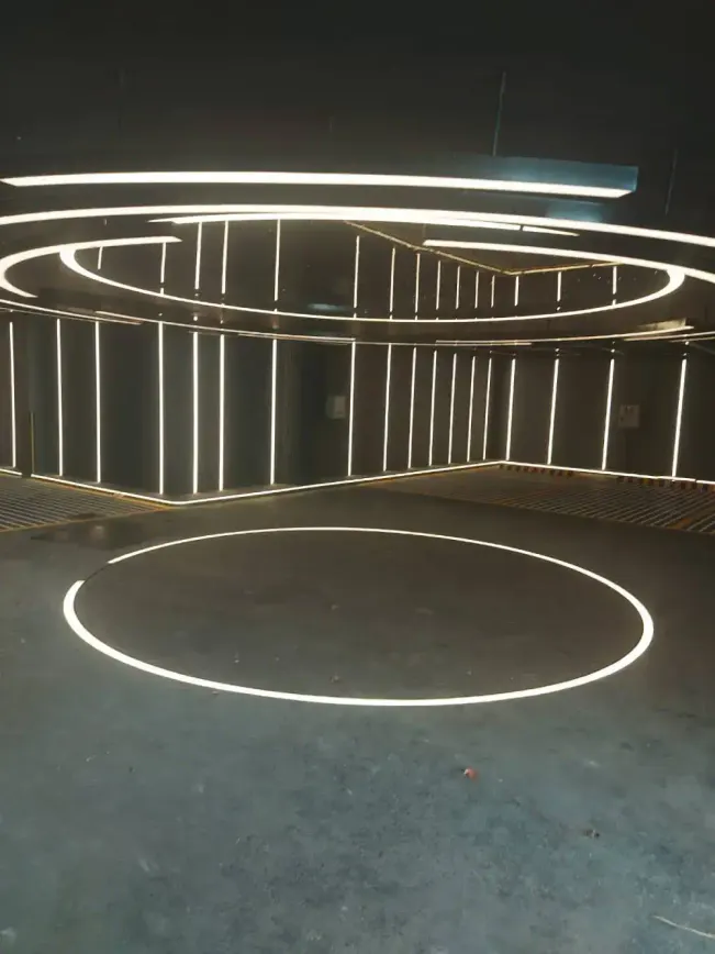 Car turntable outlined by a glowing LED ring under circular ceiling lights in a residential garage in Dubai Hills, Dubai
