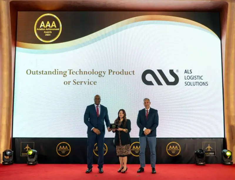 ALS receiving the Outstanding Technology Product or Service award on a red stage at the Aviation Achievement Awards 2024