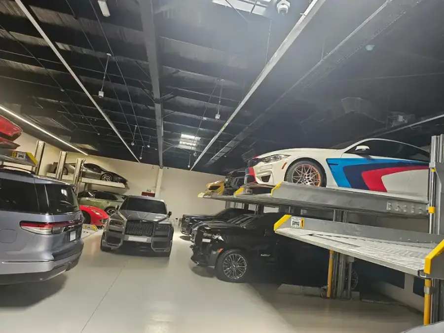 Luxury cars on double car stacker lifts in a car dealership garage on Sheikh Zayed Road, Dubai